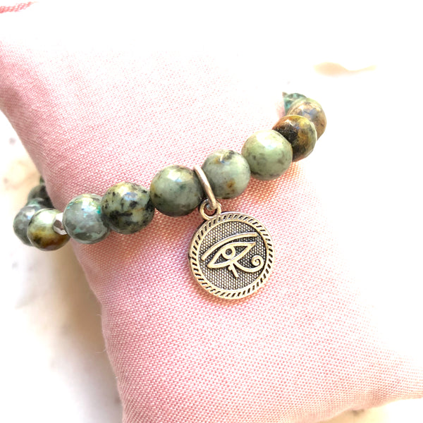 Aria Mala Atelier's unique one-of-a-kind African Turquoise, Natural Sandalwood RA (Eye of Horus) Charm yoga bracelet for spiritual living