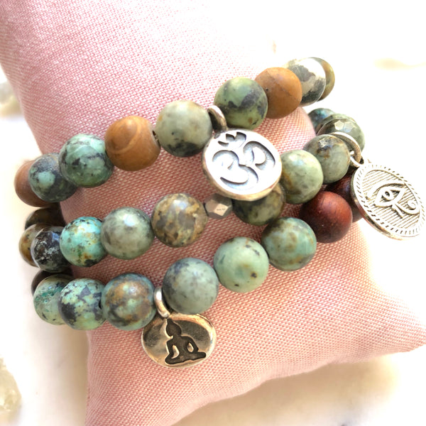 Aria Mala Atelier's unique one-of-a-kind African Turquoise, Natural Sandalwood RA (Eye of Horus) Charm yoga bracelet for spiritual living