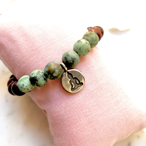 Aria Mala Atelier's unique one-of-a-kind African Turquoise, Natural Sandalwood yoga bracelet with RA, Yoga, OM charm for spiritual living