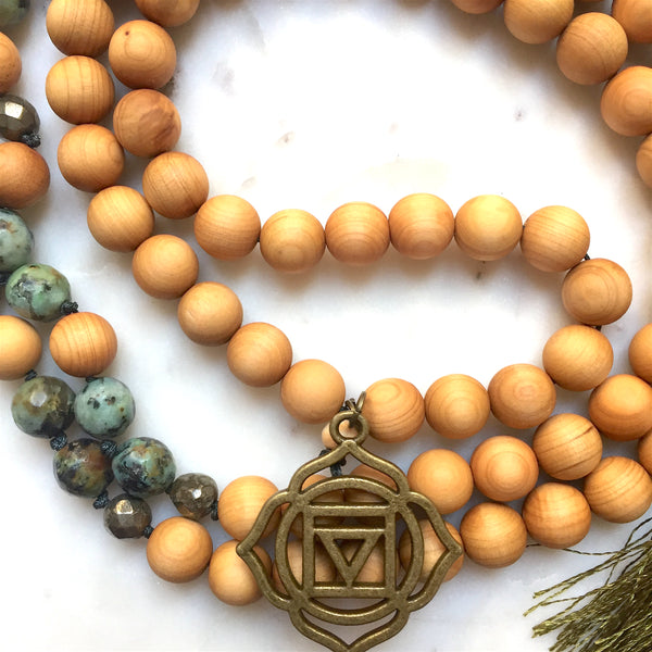 Aria Mala Atelier's unique one-of-a-kind African turquoise gemstone meditation japa mala with first (root) chakra charm is for yoga meditation empowering spiritual daily practise and intention setting