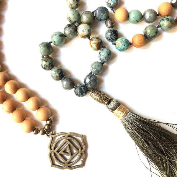 Aria Mala Atelier's unique one-of-a-kind African turquoise gemstone meditation japa mala with first (root) chakra charm is for yoga meditation empowering spiritual daily practise and intention setting