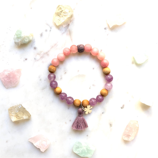 Aria Mala Atelier's unique one-of-a-kind Mat Rose & Lilac Jade, Natural Sandalwood yoga bracelet with sterling silver clover charm and mini lilac tassel for spiritual living