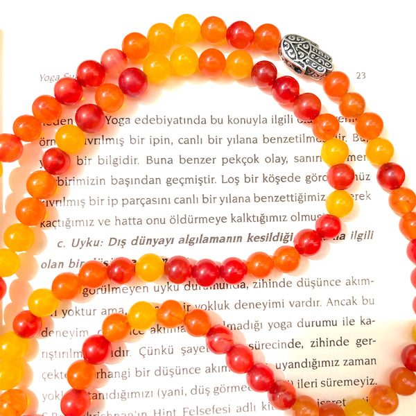 Aria Mala Atelier's unique one-of-a-kind sun color agate gemstone meditation japa mala with silver hamsa charm is for yoga meditation empowering spiritual, mindfulness daily practise, intention setting