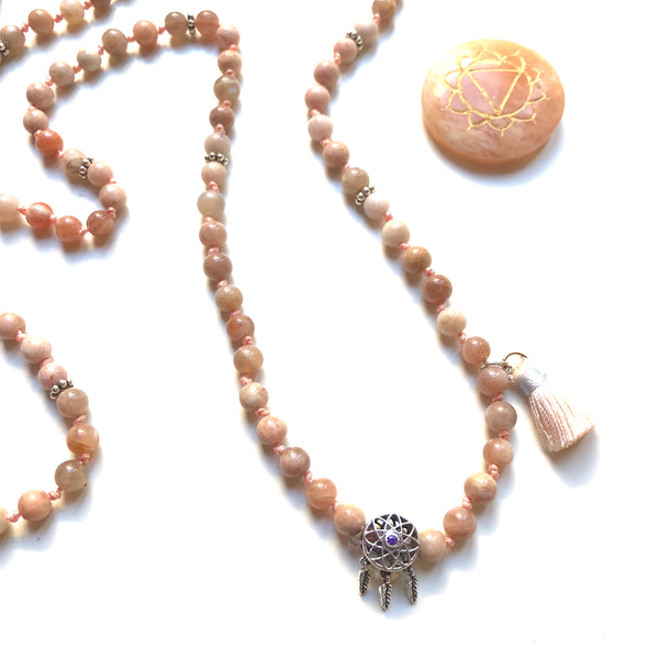 Aria Mala Atelier's unique one-of-a-kind feminine power Peach Moonstone gemstone meditation japa mala with sterling silver dream catcher charm is for yoga meditation empowering spiritual daily practise and intention setting