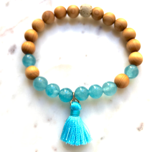 Aria Mala Atelier's unique one-of-a-kind Turquoise Jade, Natural Sandalwood yoga bracelet with cotton mini tassel for spiritual living