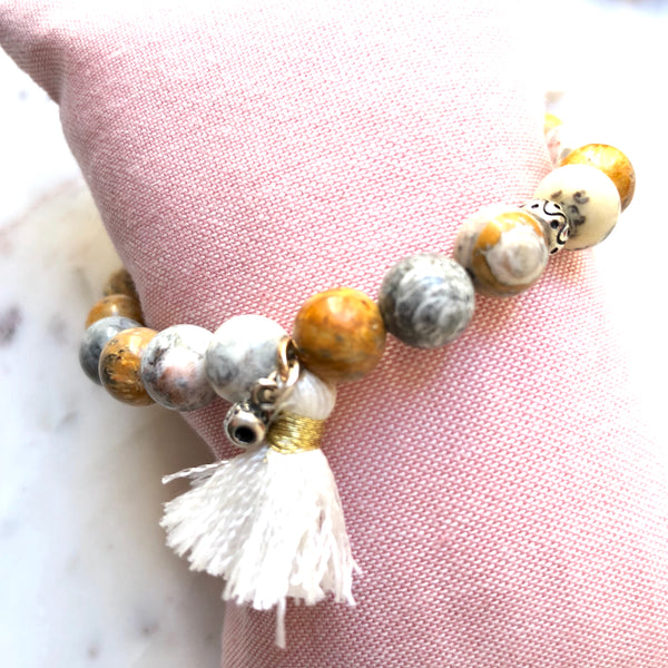 Aria Mala Atelier's unique one-of-a-kind sky eye jasper bracelet with cotton tassel for spiritual living