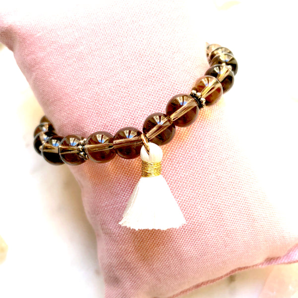 Aria Mala Atelier's unique one-of-a-kind smoky quartz yoga bracelet with mini cotton tassel for spiritual living