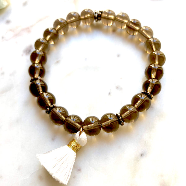 Aria Mala Atelier's unique one-of-a-kind smoky quartz yoga bracelet with mini cotton tassel for spiritual living