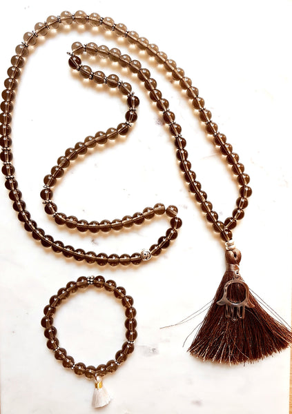 Aria Mala Atelier's unique one-of-a-kind brown smoky quartz gemstone meditation japa mala with silver Hamsa charm is for yoga meditation spiritual daily practise and intention setting