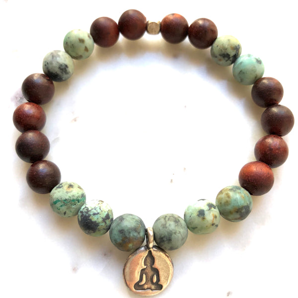 Aria Mala Atelier's unique one-of-a-kind African Turquoise, Natural Sandalwood yoga bracelet with RA, Yoga, OM charm for spiritual living