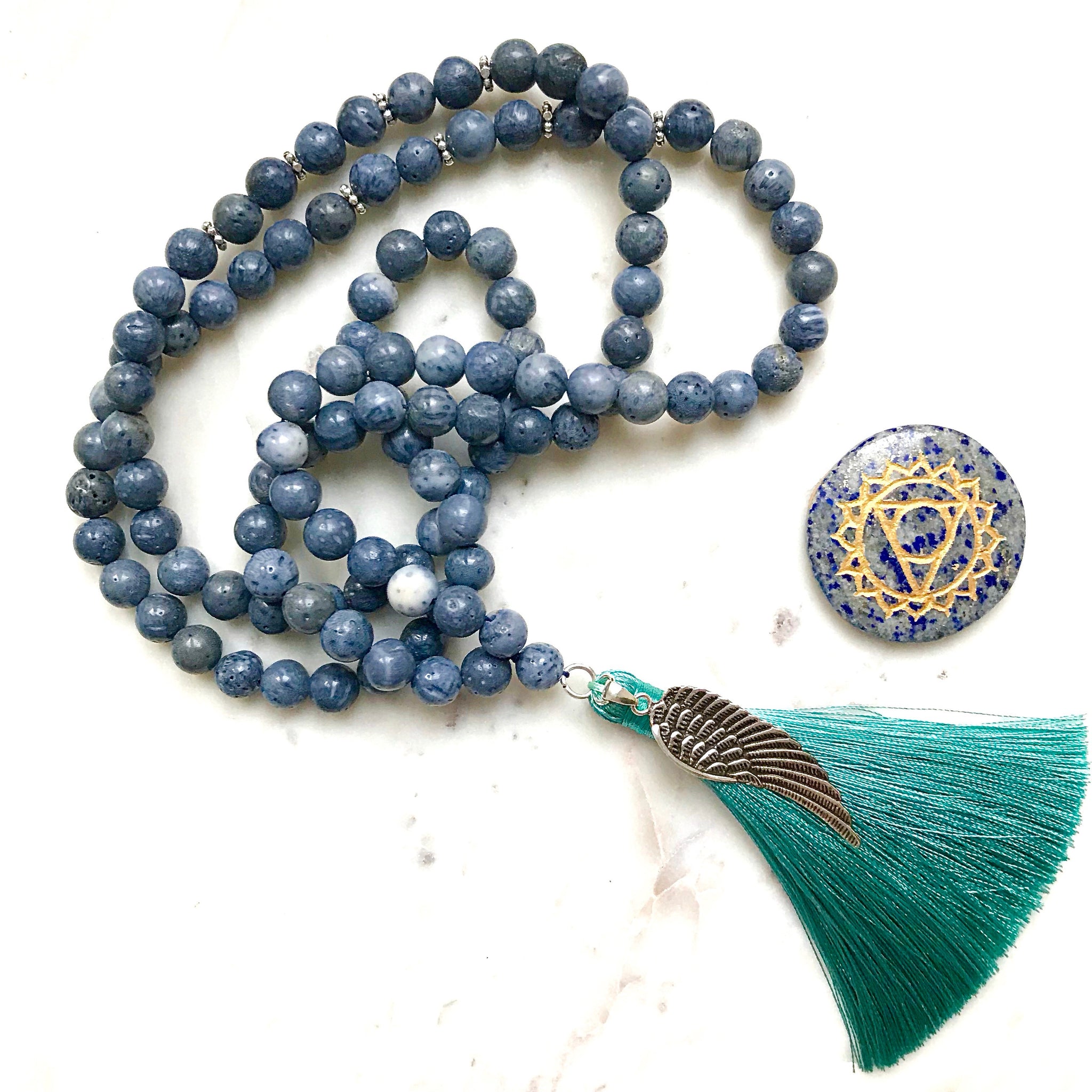 Aria Mala Atelier's unique one-of-a-kind blue coral gemstone meditation japa mala with angel wing silver charm is for yoga meditation empowering spiritual daily practise and intention setting