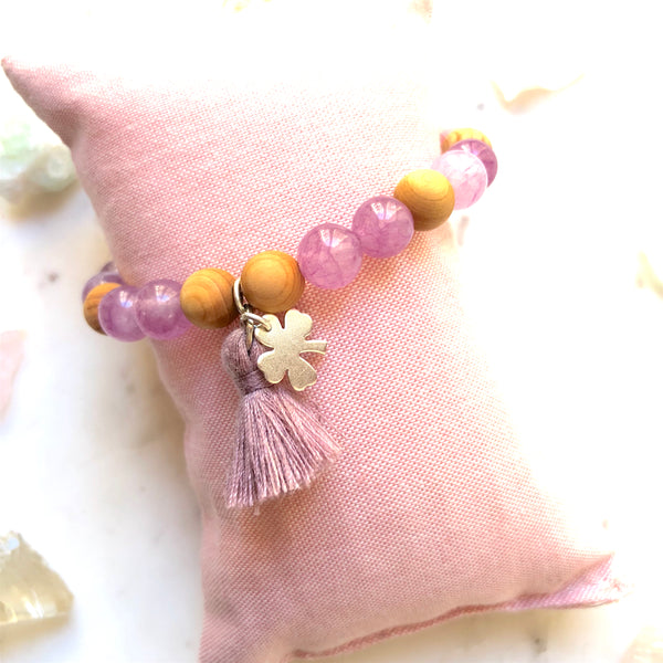 Aria Mala Atelier's unique one-of-a-kind Mat Rose & Lilac Jade, Natural Sandalwood yoga bracelet with sterling silver clover charm and mini lilac tassel for spiritual living