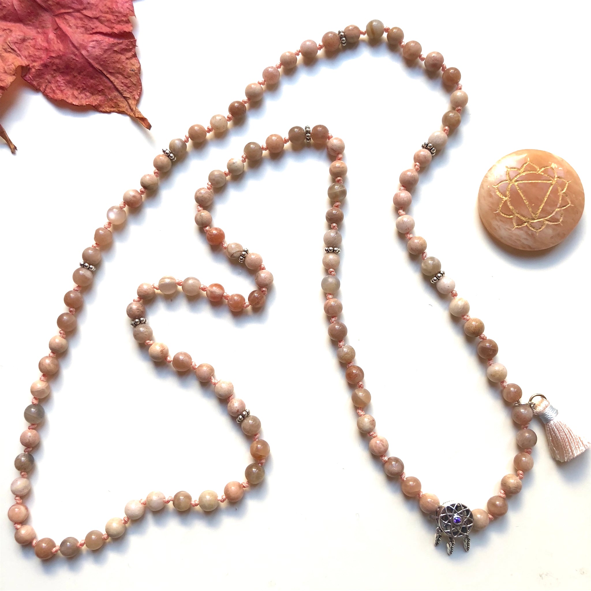 Aria Mala Atelier's unique one-of-a-kind feminine power Peach Moonstone gemstone meditation japa mala with sterling silver dream catcher charm is for yoga meditation empowering spiritual daily practise and intention setting