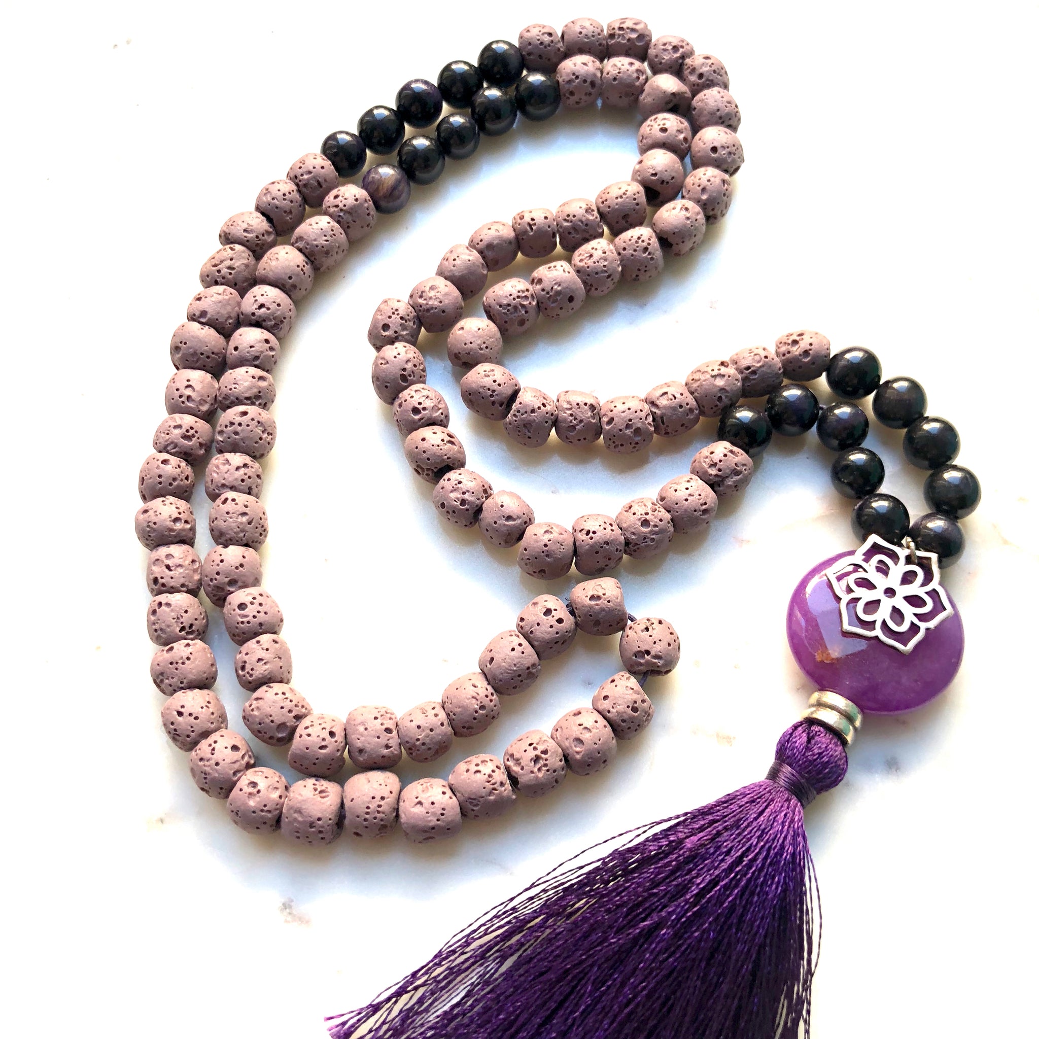 Aria Mala Atelier's unique one-of-a-kind lilac lavastone, purple jade gemstone meditation japa mala with silver mandala charm is for yoga meditation empowering spiritual daily practise and intention setting