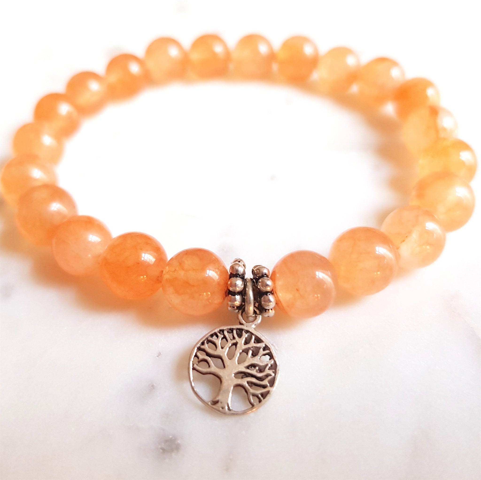 Aria Mala Atelier's unique one-of-a-kind salmon jade yoga bracelet with sterling silver Tree of life charm for spiritual living